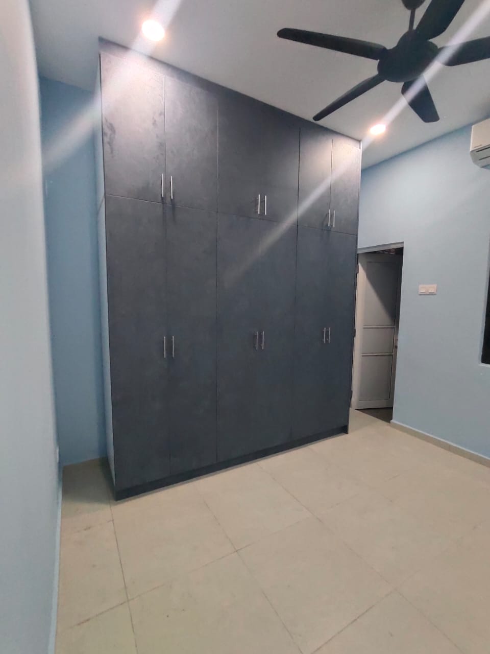 Full-height dark bedroom wardrobe with overhead storage and silver handles