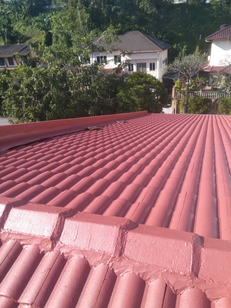 Residential roofing project showing rows of red roof tiles and ridge tiles